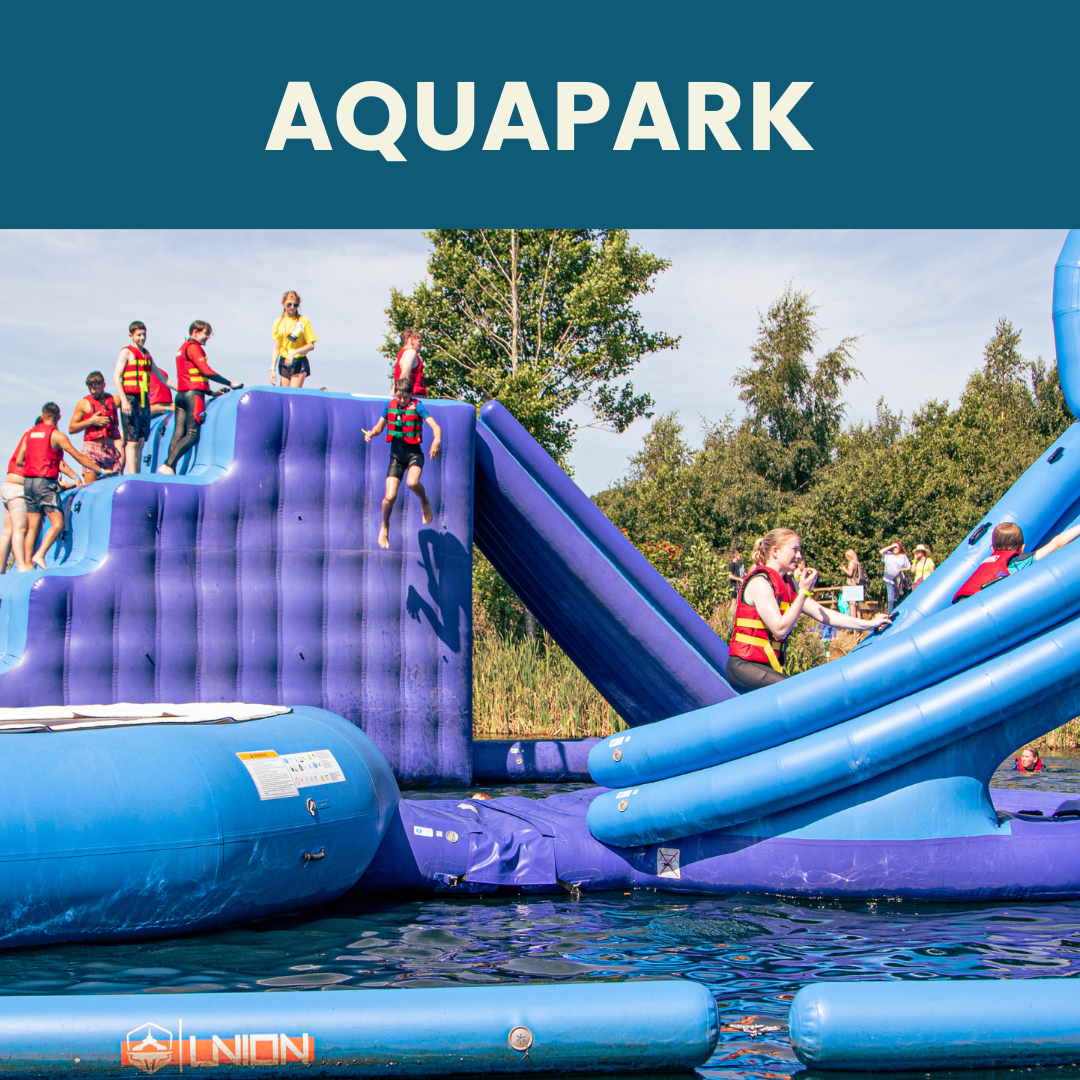 children sliding on inflatable park on lake