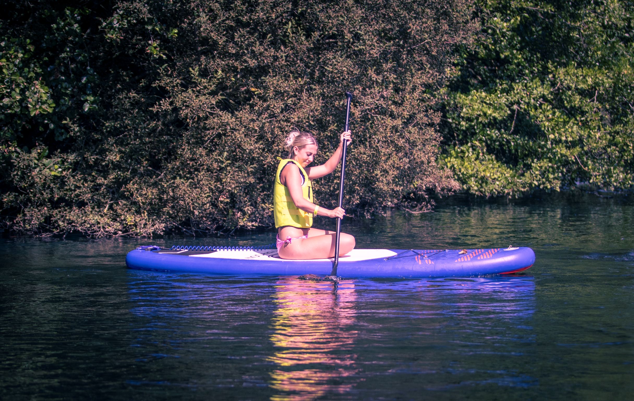 Woman Paddleboarding on Water